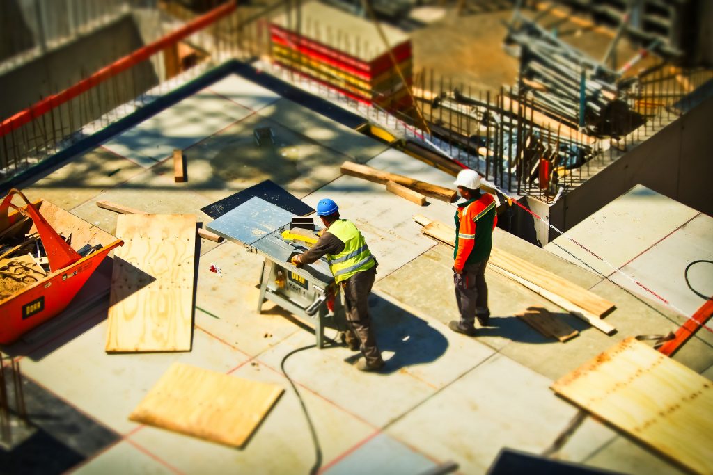 Two men working on a construction site with construction insurance