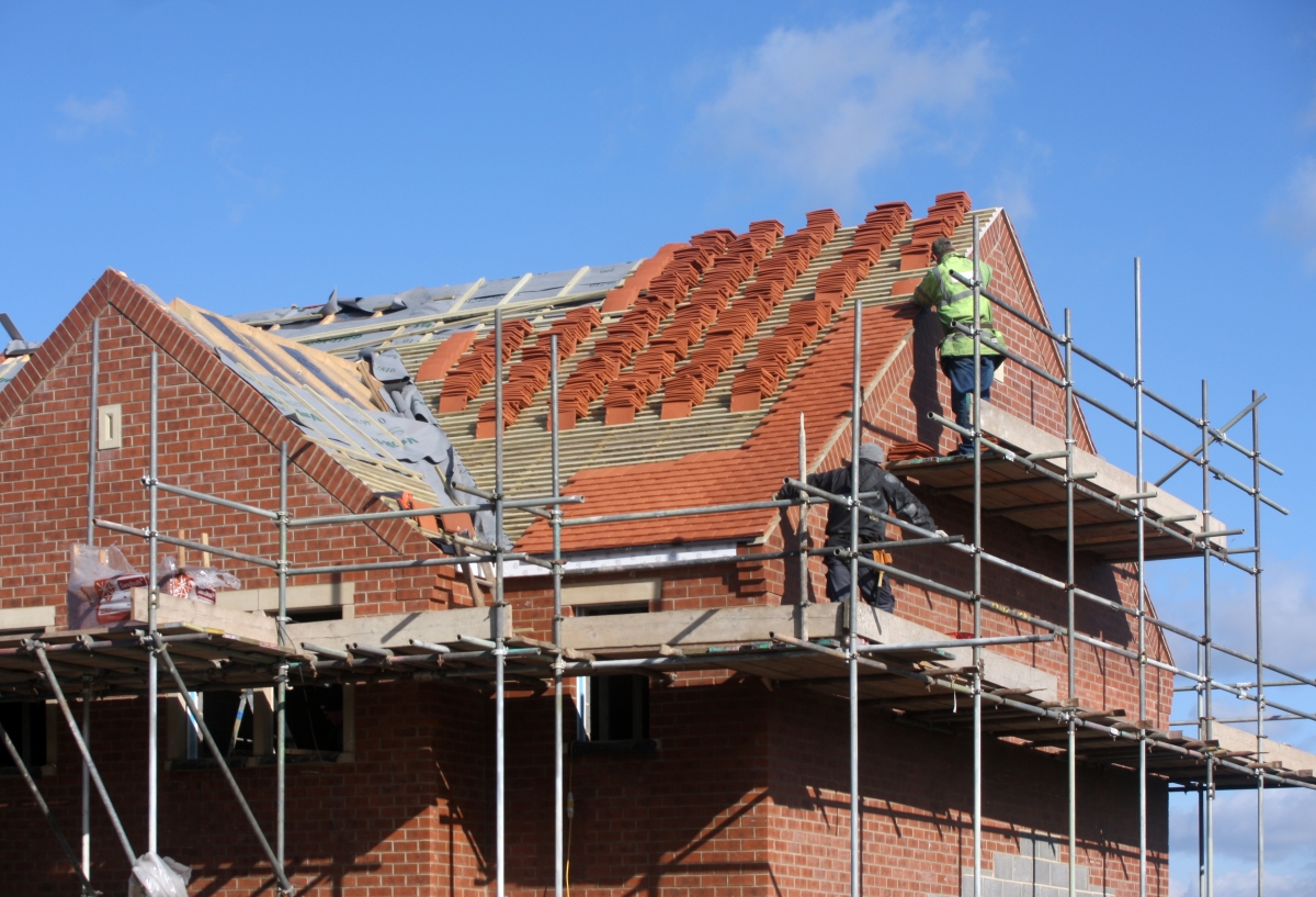 self build house under construction with insurance