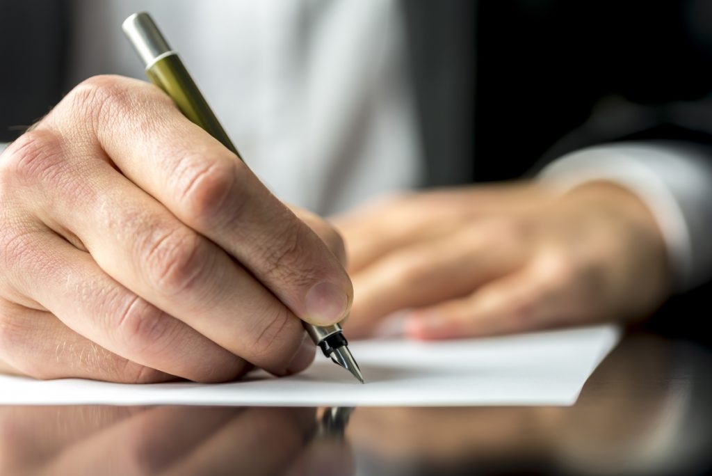 Gentleman signing insurance paper